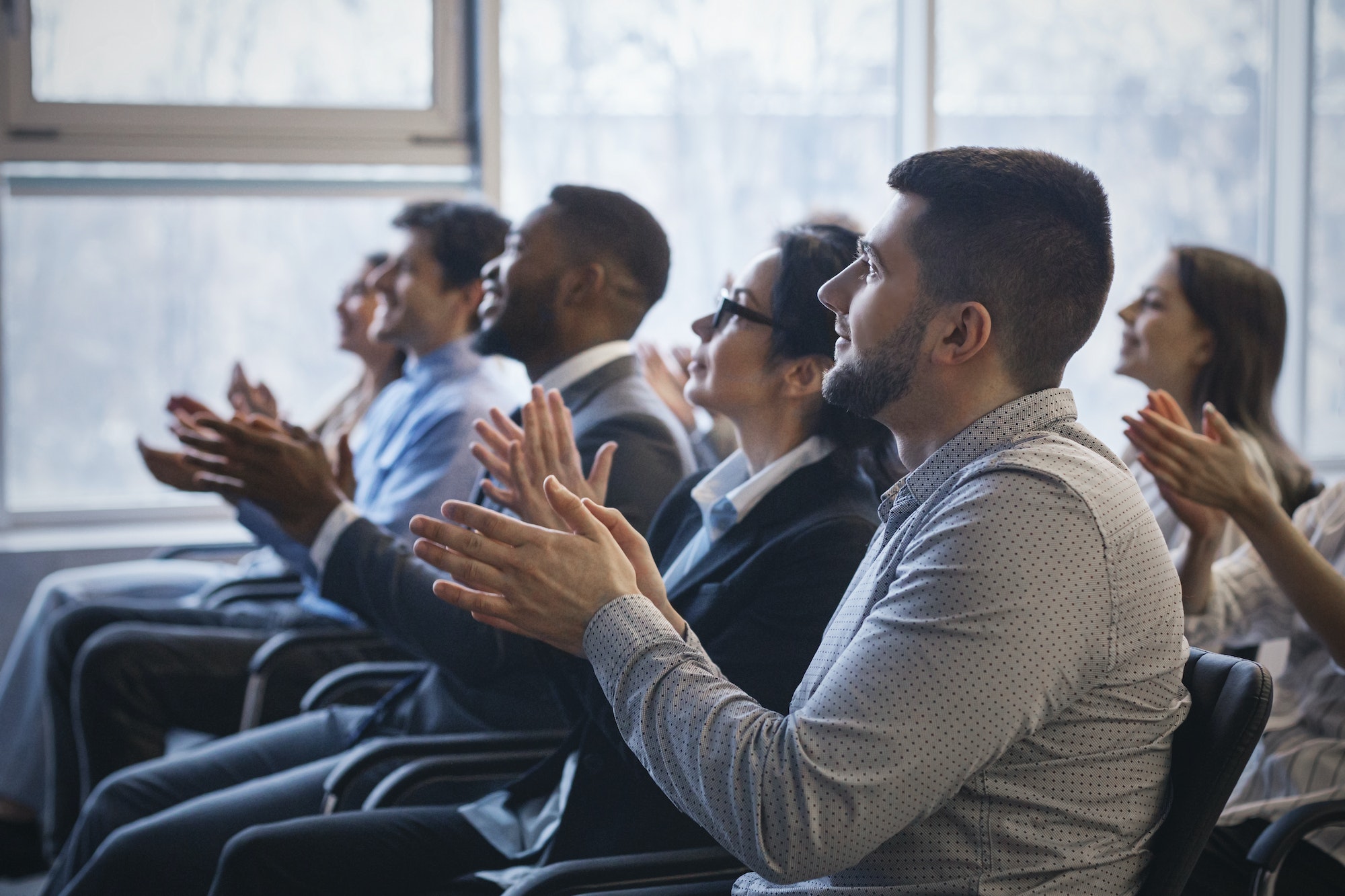Business conference. Colleagues clapping hands to speaker